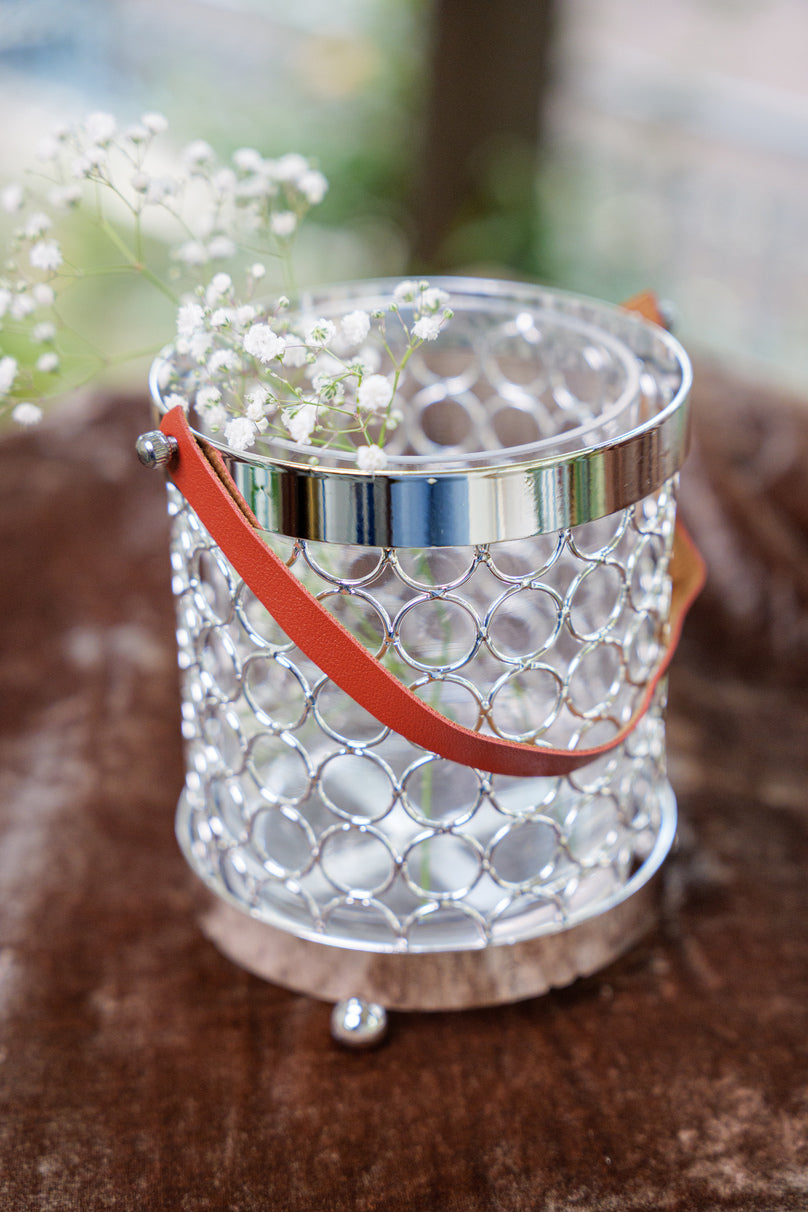 Glass jar with metal basket holder