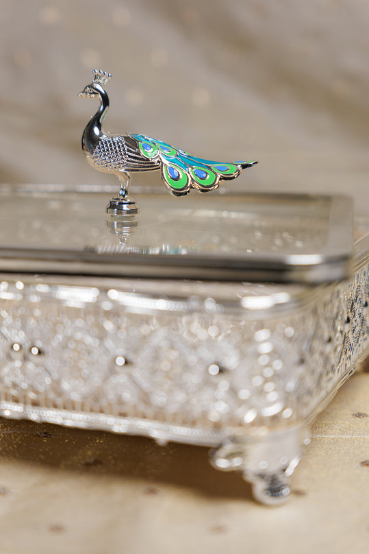 Decorative silver glass box with peacock design