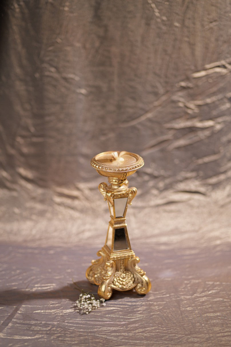 Golden resin candle stand with mirror accents