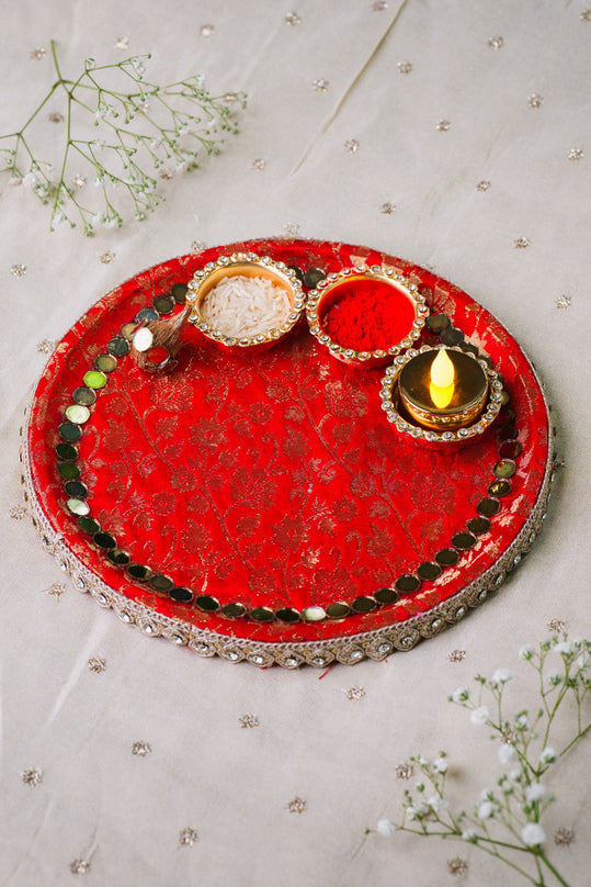 Red mirror work pooja thali with velvet base